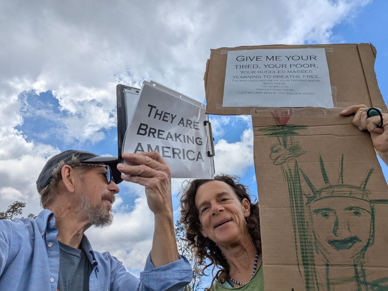 Breaking America protest sign with Statue of Liberty