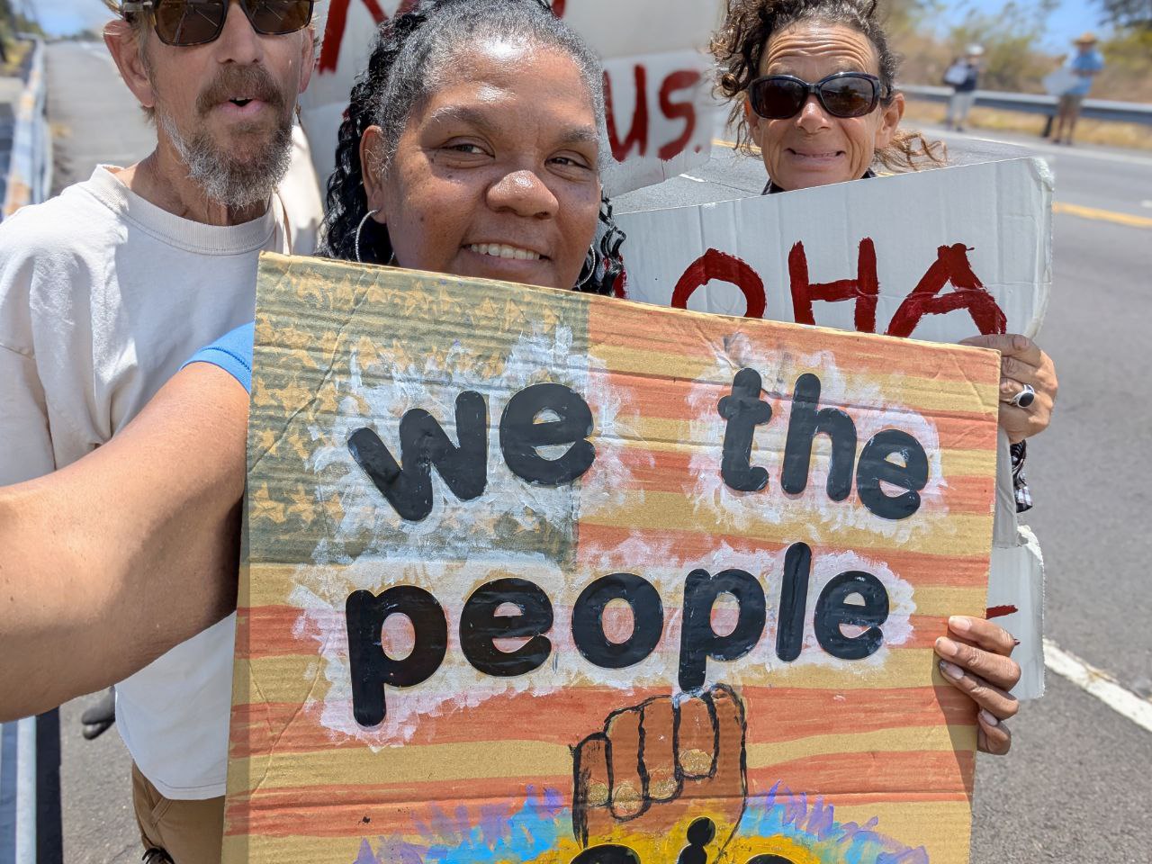 Community rally with We The People sign